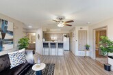 Located at 1512 Hollowhill Drive in Bryan, TX, this single-story residence offers a functional and thoughtfully designed floor plan with two bedrooms, two bathrooms, and two closets. The living room serves as a welcoming centerpiece, featuring wood-look flooring, multiple windows with blinds that invite abundant natural light, and direct access to the front entry. The space is well-suited for both relaxing and entertaining.

The kitchen is outfitted with gray cabinetry, white countertops, and white appliances, including a range, dishwasher, microwave, and refrigerator. A peninsula with bar seating connects the kitchen to the living area, enhancing the open-concept feel. Wood-look flooring continues throughout the main living spaces, providing a cohesive aesthetic.

Both bedrooms are carpeted and equipped with ceiling fans. The primary bedroom is generously sized, featuring a dedicated closet and direct access to its own bathroom. The secondary bedroom offers a comfortable layout with a window for natural light. Both bathrooms include tub-shower combinations, wood-look flooring, and light cabinetry with white countertops, maintaining a consistent, clean design throughout.

Overall, this residence presents a practical and comfortable layout with modern finishes suited for everyday living in Bryan, TX.