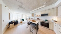 Located at 39 Bruton Street in San Francisco's 94130 zip code, this thoughtfully designed one-bedroom, one-bathroom residence offers a clean, contemporary aesthetic across a single well-organized floor. The open-concept kitchen and living area forms the heart of the home, where light wood cabinetry, a white subway tile backsplash, concrete countertops, and stainless steel appliances create a functional yet stylish culinary space. A freestanding island with a marble-top surface and bar seating adds both utility and visual appeal. The living area receives an abundance of natural light through large floor-to-ceiling windows, framing outdoor views and enhancing the airy atmosphere. Exposed concrete ceilings throughout lend an industrial-modern character, grounded by warm light wood flooring. The bedroom is a serene retreat, featuring oversized windows, ample closet space, and access to additional storage. The bathroom is finished with clean white vertical tile surrounding a full soaking tub and shower combination, maintaining the home's crisp, minimalist palette. A hallway connects the spaces efficiently, with two closets providing generous storage. The overall ambiance is calm, bright, and modern — a refined urban residence in San Francisco.