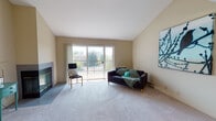 Located at 4070 Fitzpatrick Way in Santa Clara, California, this single-floor residence offers a well-organized layout with distinct living, sleeping, and functional zones. The living room serves as the focal point of the home, featuring vaulted ceilings that lend an open, airy quality to the space. A fireplace anchors one wall, while large sliding glass doors open directly onto a private balcony, inviting abundant natural light and outdoor views of surrounding greenery. Soft carpeting throughout the living area adds warmth underfoot.

The galley-style kitchen is efficiently arranged with ample cabinetry in a mix of white and warm wood tones, a built-in range, refrigerator, and a sink positioned along the opposite counter, making practical use of the space. Light tile flooring runs through the kitchen for easy maintenance.

The bedrooms are carpeted and well-proportioned, each benefiting from windows that frame outdoor views. One bedroom features a spacious built-in closet with wire shelving for organized storage. The bathrooms include a full bath with a shower-tub combination and a second bath with a walk-in glass-enclosed shower stall, a single-sink vanity with ample counter space, and tile flooring throughout. The overall ambiance of the unit is calm and neutral, with a clean, functional aesthetic well-suited to the Silicon Valley location.