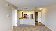 Located at 103 Melville Loop in Chapel Hill, NC, this single-floor residence offers a practical and comfortable layout designed for everyday living. The open-concept kitchen serves as a central feature, boasting granite countertop surfaces, white cabinetry, and a full suite of stainless steel appliances including a refrigerator, range, and microwave. A peninsula with an integrated sink provides additional prep space and creates a natural divide between the kitchen and the carpeted living area, which offers a spacious, open feel with neutral wall tones throughout.

The bedrooms are generously sized, each featuring plush carpeting, soft neutral walls, and ample closet space with built-in shelving. Natural light filters in through windows, keeping the rooms bright and inviting. A dedicated built-in shelving unit provides additional storage options within the unit.

The bathroom is finished with classic white subway-style wall tile surrounding a full soaking tub and shower combination with chrome fixtures. A dedicated laundry area houses a stacked washer and dryer unit alongside a water heater, adding functional convenience. The consistent use of neutral tones and clean finishes throughout gives the space a cohesive, move-in-ready appearance.