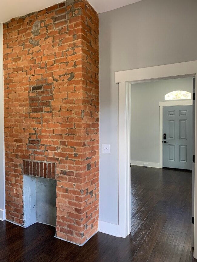Exposed brick accents high ceilings and spacious rooms. - 1217 Wheeler St