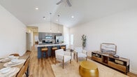 Located at 6616 Fallstone Rd in Fort Smith, Arkansas, this single-story, 3-bedroom, 2-bathroom home offers a well-designed open-concept layout with modern finishes throughout. The combined kitchen and living area is the heart of the home, anchored by soaring vaulted ceilings and a ceiling fan that enhance the sense of spaciousness. Warm luxury vinyl plank flooring runs throughout the main living areas, complementing the bright, neutral palette. The kitchen is a standout feature, showcasing gray shaker-style cabinetry, granite countertops, stainless steel appliances, and a large center island with bar seating and pendant lighting above — ideal for both cooking and entertaining. The living room benefits from natural light through a front-facing window and flows seamlessly into the rest of the home. Each of the three bedrooms offers a comfortable layout with ceiling fans and recessed lighting. The primary bedroom includes a spacious walk-in closet with built-in shelving and hanging rods. Both bathrooms feature granite-topped vanities with gray cabinetry, consistent with the home's cohesive design. A dedicated laundry room with washer and dryer hookups adds everyday convenience. The attached garage provides ample storage and parking space, completing this thoughtfully appointed home.