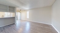 Located at 4341 Spring St in La Mesa, CA, this well-laid-out one-bedroom, one-bathroom unit offers a comfortable and functional single-level floor plan. The combined kitchen and living area serves as the heart of the home, featuring light luxury vinyl plank flooring, neutral wall tones, and a textured ceiling throughout. A ceiling fan adds both style and practicality to the living room, which is brightened by vertical windows and a sliding glass door that invites natural light into the space.

The kitchen is efficiently designed with white cabinetry, light countertops, a double-basin sink, and a full suite of white appliances including a range and refrigerator, offering ample storage and workspace. A pass-through connects the kitchen seamlessly to the living area.

The spacious bedroom features plush carpeting, a large window with vertical blinds that allows for natural light and outdoor views, and a dedicated closet for storage. The bathroom is clean and straightforward, complete with a shower/tub combination and essential fixtures. A hallway connects the private spaces of the unit efficiently. Overall, the space presents a bright, neutral, and move-in-ready environment in a convenient La Mesa location.