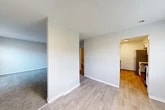 Located at 20 Braemar Dr in Liverpool, NY, this two-story home offers a practical and comfortable layout across three bedrooms and two bathrooms. The main floor houses the living room, dining room, and kitchen, with a mix of light wood-look flooring and carpet providing a clean, cohesive aesthetic throughout. The kitchen is well-appointed with white shaker-style cabinetry, light stone countertops, stainless steel appliances including a refrigerator, microwave, and dishwasher, and light hardwood-style flooring that ties the space together. The living and dining areas flow naturally, connected by a central hallway that leads to the staircase. Upstairs, three carpeted bedrooms offer comfortable retreats, each finished with neutral tones and textured ceilings. The primary bedroom is generously sized and benefits from two windows that bring in natural light, along with baseboard heating. Multiple closets — five in total throughout the home — provide exceptional storage. The secondary bedrooms each include their own closet space. Two bathrooms serve the home, finished with clean, minimal fixtures. The overall interior palette of soft grays and whites, combined with textured ceilings and clean white trim, gives the home a bright, move-in-ready feel.
