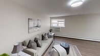 Located at 831 Cedar Ave in Bensalem, PA, this single-floor residence offers a thoughtfully laid-out living space with a neutral, contemporary aesthetic throughout. The open-plan living and dining area is anchored by durable wood-look flooring, large windows that invite natural light, and a warm, understated color palette. The living area comfortably accommodates seating and is accented with modern décor, while the adjacent dining space provides a natural flow for everyday living and entertaining. The kitchen is well-appointed with white shaker-style upper cabinets, dark lower cabinets, a classic subway tile backsplash, and a full suite of stainless steel appliances including a gas range, microwave, and refrigerator. Light wood-look flooring and a window above the sink add brightness to the space. The bedrooms are carpeted and finished in soft, neutral tones, each featuring a window with natural light, baseboard heating, and ample room for furnishings. One bedroom includes a closet and direct hallway access, lending it functionality as a primary bedroom. The overall ambiance of the unit is clean, modern, and move-in ready, with consistent finishes and a practical layout suited for comfortable daily living.