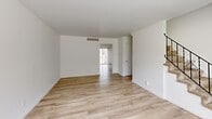 Located at 240 Chez Vant Dr in Hazelwood, MO, this two-story, 2-bedroom, 2-bathroom home offers a clean, modern aesthetic throughout. The main floor features light wood-style flooring that flows seamlessly across the living area and into the kitchen. A large window at the front of the living room fills the space with natural light, while a staircase with a sleek metal railing connects to the upper level. The kitchen is well-appointed with white shaker cabinetry, butcher block countertops, subway tile backsplash, and a full suite of stainless steel appliances including a refrigerator, dishwasher, and range. Upstairs, the two bedrooms continue the light wood-style flooring and feature crisp white walls and windows with outdoor views of the surrounding greenery. Both bathrooms are functional and neatly finished, with one featuring tile flooring and a tub/shower combo with sliding glass doors and a vanity with ample counter space. The upper floor also provides additional living area beyond the bedrooms. Outside, a private fenced patio offers a dedicated outdoor retreat. The home's neutral palette and updated finishes create a bright, inviting atmosphere throughout.