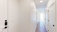 Located at 9520 Antora Grove in Colorado Springs, CO, this thoughtfully designed two-bedroom, two-bathroom single-story home offers a clean, modern aesthetic throughout. Light wood-look flooring flows continuously across the open layout, complemented by crisp white walls and recessed lighting that create a bright, welcoming atmosphere.

The kitchen serves as a functional centerpiece, featuring light wood cabinetry extending to the ceiling, a herringbone tile backsplash, stainless steel appliances including a gas range, microwave, and refrigerator, and a large island with quartz countertops and an undermount sink with a sleek industrial-style faucet.

The living room is a standout space, bathed in natural light from expansive windows that frame sweeping views of the Colorado landscape and distant mountains, filling the room with sunlight and scenic beauty.

Both bedrooms are well-proportioned and bright, with large windows offering outdoor views and ceiling fans for added comfort. The primary bedroom includes its own dedicated bathroom featuring light wood vanity cabinetry, tile flooring, and built-in shelving. The second bathroom offers a tub-shower combination with marble-style tile surround and matte black fixtures.

A dedicated laundry area, ample closet space, a welcoming entrance, and a central hallway with recessed lighting complete this well-appointed home.