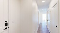 Located at 9520 Antora Grove in Colorado Springs, CO, this thoughtfully designed two-bedroom, two-bathroom single-story home offers a clean, modern aesthetic throughout. Light wood-look flooring flows continuously across the open layout, complemented by crisp white walls and recessed lighting that create a bright, welcoming atmosphere.

The kitchen serves as a functional centerpiece, featuring light wood cabinetry extending to the ceiling, a herringbone tile backsplash, stainless steel appliances including a gas range, microwave, and refrigerator, and a large island with quartz countertops and an undermount sink with a sleek industrial-style faucet.

The living room is a standout space, bathed in natural light from expansive windows that frame sweeping views of the Colorado landscape and distant mountains, filling the room with sunlight and scenic beauty.

Both bedrooms are well-proportioned and bright, with large windows offering outdoor views and ceiling fans for added comfort. The primary bedroom includes its own dedicated bathroom featuring light wood vanity cabinetry, tile flooring, and built-in shelving. The second bathroom offers a tub-shower combination with marble-style tile surround and matte black fixtures.

A dedicated laundry area, ample closet space, a welcoming entrance, and a central hallway with recessed lighting complete this well-appointed home.