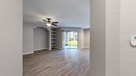 This contemporary 1040 square foot home in Orlando, FL offers a blend of style and functionality. The single-story layout encompasses three bedrooms, including a spacious 180 square foot primary bedroom, and two well-appointed bathrooms. The heart of the home is an open-concept living area, showcasing a modern kitchen with sleek white cabinetry, stainless steel appliances, and ample counter space. Throughout the residence, warm wood-look flooring creates a cohesive and inviting atmosphere. Large windows in the bedrooms and living areas flood the space with natural light, while providing views of the surrounding greenery. The bathrooms feature clean lines with white fixtures and vanities, complemented by neutral tones. A dedicated laundry room adds convenience to daily life. The home's neutral color palette and contemporary fixtures offer a blank canvas for personalization, making it an ideal space for various lifestyle needs. With its thoughtful design and prime Orlando location, this property presents a perfect blend of comfort and modern living.