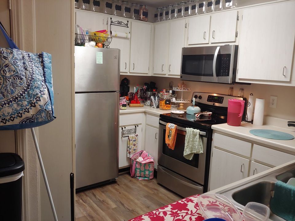 Kitchen: Roommates have filled in their stuff but you have 2-3 cupboards. - 295 Wahoo Way