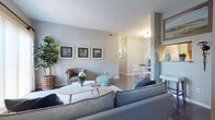 This single-floor residence offers a thoughtfully designed layout that balances comfort and functionality throughout. The open-concept living area is anchored by soft gray walls, warm hardwood-style flooring, and a large sliding glass door that welcomes natural light and provides outdoor views, creating an airy and inviting atmosphere. The space flows seamlessly into a dedicated dining nook, which features rich hardwood-style flooring and is accented by framed wall art, making it an ideal setting for everyday meals or entertaining.

The kitchen is well-equipped with granite countertops, a mosaic tile backsplash, gray cabinetry with modern hardware, a stainless steel sink, and stainless steel appliances including a range and refrigerator — offering both style and practicality.

Two bedrooms provide comfortable retreats, each featuring hardwood-style flooring and windows that allow natural light to filter in. The primary bedroom includes a ceiling fan, ample space, and a calm, neutral color palette. The second bedroom mirrors this restful aesthetic with clean lines and soft tones.

The bathroom is finished with a granite-topped vanity featuring a navy blue cabinet, a full tub-shower combination, and hardwood-style flooring, completing this cohesive and well-maintained residence.