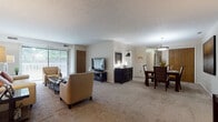 Located at Darrow Park Drive in Twinsburg, Ohio, this single-floor residence offers a comfortable and functional layout with thoughtfully designed living spaces. The open-plan living and dining area is bright and welcoming, featuring plush carpeting, a textured ceiling, and large sliding glass doors with vertical blinds that invite abundant natural light and provide access to the outdoors. The living room offers generous seating space, while the adjacent dining area is defined by a stylish pendant light fixture and warm, neutral tones throughout.

The kitchen is efficiently laid out with ample white cabinetry, a gas range, dishwasher, refrigerator, and a window above the sink that brightens the workspace. Light flooring and warm-toned countertops complete the practical design.

The primary bedroom features a bold accent wall, plush carpeting, and a large window with vertical blinds, creating a serene retreat. The second bedroom is equally comfortable, highlighted by a built-in closet with bifold doors and soft, neutral finishes. Both bathrooms are clean and functional, each offering a vanity with a wide countertop, mirror, and shower with curtain. The overall ambiance is warm, understated, and move-in ready.