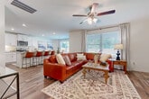 This well-appointed 3-bedroom, 2.5-bathroom two-story home offers a thoughtfully designed open-concept layout that seamlessly connects the main living areas. Rich hardwood-style flooring flows throughout, lending warmth and continuity to every room.

The living room serves as the heart of the home, featuring a ceiling fan and recessed lighting, and opens directly into the dining and kitchen areas. The dining space is bathed in natural light from a large window with outdoor views, creating an inviting atmosphere for meals and gatherings.

The kitchen is a standout feature, outfitted with crisp white shaker cabinetry, granite countertops, a full suite of stainless steel appliances including a gas range, microwave, dishwasher, and French door refrigerator, and a breakfast bar with seating — ideal for casual dining or entertaining.

A dedicated in-unit laundry room with full-size washer and dryer adds everyday convenience. The bathrooms are finished with white cabinetry, clean countertops, and tub-shower combinations. The primary bedroom is generously sized with a ceiling fan and ample closet space, offering a comfortable retreat.

Neutral white walls, recessed lighting, and consistent finishes throughout give this home a clean, modern aesthetic across both floors.