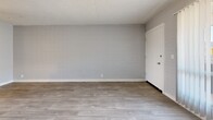 Located at 2925 N Greenfield Rd in Phoenix, AZ, this one-bedroom, one-bathroom unit offers a compact and efficiently designed single-floor layout. Throughout the space, light wood-look flooring and soft gray walls create a clean, neutral palette, while textured ceilings add a classic finishing detail.

The living room is a bright, open area featuring a large sliding glass door dressed with vertical blinds, allowing abundant natural light and outdoor views. The painted concrete block walls add a subtle architectural character to the space.

The bedroom is a well-proportioned room featuring a sliding double-door closet for ample storage. A window with vertical blinds brings in natural light, and the same light flooring ties the space together cohesively.

The bathroom is clean and functional, featuring a white vanity with a single sink, a large mirror, and light flooring consistent with the rest of the unit. An adjacent dedicated closet provides additional storage.

The overall ambiance of the unit is bright and clean, with a minimalist aesthetic that offers a versatile canvas for personalization. The consistent use of light tones and natural light throughout makes the space feel open and welcoming.