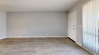 Located at 2925 N Greenfield Rd in Phoenix, AZ, this one-bedroom, one-bathroom unit offers a compact and efficiently designed single-floor layout. Throughout the space, light wood-look flooring and soft gray walls create a clean, neutral palette, while textured ceilings add a classic finishing detail.

The living room is a bright, open area featuring a large sliding glass door dressed with vertical blinds, allowing abundant natural light and outdoor views. The painted concrete block walls add a subtle architectural character to the space.

The bedroom is a well-proportioned room featuring a sliding double-door closet for ample storage. A window with vertical blinds brings in natural light, and the same light flooring ties the space together cohesively.

The bathroom is clean and functional, featuring a white vanity with a single sink, a large mirror, and light flooring consistent with the rest of the unit. An adjacent dedicated closet provides additional storage.

The overall ambiance of the unit is bright and clean, with a minimalist aesthetic that offers a versatile canvas for personalization. The consistent use of light tones and natural light throughout makes the space feel open and welcoming.