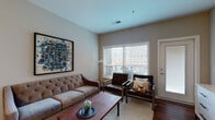 Located at 830 Burr Ave in the desirable Grandview Heights neighborhood of Columbus, Ohio, this well-designed single-floor residence offers a thoughtful layout with modern finishes throughout. The living area is warm and inviting, featuring rich hardwood flooring, neutral wall tones, and large windows dressed with white blinds that allow generous natural light to flow through while framing views of the surrounding urban streetscape. The kitchen is a functional centerpiece of the home, boasting granite countertops, white and gray cabinetry, a full suite of stainless steel appliances, a subway tile backsplash, and a spacious island with seating for multiple guests, illuminated by stylish pendant lighting overhead. The bedroom is generously proportioned with plush carpeting, ample natural light, and direct access to a walk-in closet outfitted with built-in shelving. The full bathroom is clean and contemporary, featuring tile flooring, a vanity with under-sink storage, a framed mirror, and a glass-enclosed shower. Throughout the residence, consistent neutral tones, clean lines, and quality materials create a cohesive and comfortable living environment suited for modern urban living in one of Columbus's most sought-after communities.
