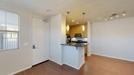 Located at 20455 Sorrento Lane in Los Angeles, CA, this thoughtfully designed one-bedroom, one-bathroom residence offers a practical and comfortable layout across a single floor. Upon entry, rich hardwood-style flooring extends through the open living area, creating a warm and cohesive aesthetic. The living room is bright and airy, with multiple windows fitted with blinds that allow abundant natural light to fill the space.

The kitchen is a standout feature, designed in a galley style with light wood cabinetry, dark granite countertops, and stainless steel appliances including a gas range, built-in microwave, refrigerator, and dishwasher. A peninsula with pendant lighting serves as both a prep area and casual dining counter, seamlessly connecting the kitchen to the living space.

The generously sized primary bedroom features plush carpet flooring, a ceiling fan, and windows that invite natural light. It includes a large walk-in closet with built-in shelving, providing excellent storage. The bathroom offers a wood-toned vanity with granite countertops, a framed mirror, and a separate tub and shower area. A hallway connects the rooms efficiently, completing this well-organized and functional floor plan.