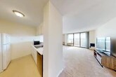 Located at 601 S Townsend St in Syracuse, NY, this one-bedroom, one-bathroom residence offers a thoughtfully laid-out single-floor plan with a comfortable and functional design throughout. The living room is a bright, open space anchored by large sliding glass doors that lead to a private balcony, flooding the room with natural light and offering elevated views of the surrounding cityscape. Neutral-toned carpeting flows throughout the living and bedroom areas, contributing to a warm and cohesive atmosphere. The kitchen is efficiently designed with white cabinetry, built-in appliances, and a pass-through window that connects it to the living room, creating an open feel between the two spaces. The spacious primary bedroom features a large built-in closet with sliding panel doors and its own wall unit, offering ample storage. In total, the unit includes three closets, providing generous storage options throughout. A dedicated hallway connects the main living areas to the bathroom and bedroom, adding a sense of structure to the layout. With its elevated position, natural light, and private outdoor access, this residence offers a practical and inviting living environment in the heart of Syracuse.