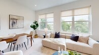 Located at 20-30 W Allens Ln in Philadelphia's desirable 19119 zip code, this well-appointed 2-bedroom, 3-bathroom residence offers a thoughtfully designed single-floor layout with a clean, contemporary aesthetic throughout. The open-concept kitchen and living area serves as the heart of the home, featuring white shaker cabinetry with brushed gold hardware, stainless steel appliances, a large waterfall-edge island with bar seating, and warm pendant lighting. Light wood-tone flooring runs throughout, enhancing the bright, airy atmosphere. The living room is bathed in natural light from oversized windows that frame lush tree-lined views, creating a serene and inviting atmosphere. The primary bedroom offers greenery views through large windows and connects to a well-appointed en-suite bathroom. Each bathroom is finished with marble-look tile, frameless glass shower enclosures, and elegant gold fixtures, maintaining a consistent design language across the home. The second bedroom is equally well-lit with its own window and access to a nearby bathroom. A dedicated hallway and closet space provide practical storage. Recessed lighting throughout ensures a clean ceiling profile, while the crisp white walls offer a neutral backdrop that complements the modern, cohesive design of this refined Philadelphia residence.