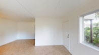 This single-floor unit offers a clean, functional layout designed for comfortable everyday living. The living area is bright and open, featuring light beige tile flooring, crisp white walls, and a sliding glass door alongside a large window that together invite generous natural light and provide views of lush greenery outside. The space flows seamlessly, creating an airy and welcoming atmosphere.

The kitchen is efficiently designed with dark espresso cabinetry, granite-style countertops, white appliances including a refrigerator and electric range, and a window overlooking the outdoors. A stacked washer and dryer unit is conveniently integrated within the kitchen area, adding practical in-unit laundry access.

The two bedrooms are well-proportioned, each featuring light tile flooring and windows that bring in natural light. One bedroom includes a closet with a built-in rod, offering useful storage. The unit includes two full bathrooms, each featuring a tub and shower combination with full tile surround, tile flooring, and vanities with granite-style countertops — one bathroom with a framed mirror and dark wood cabinetry, providing a polished finish. Throughout the unit, the neutral color palette and consistent flooring create a cohesive and move-in ready environment.
