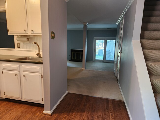 Front foyer, stairs to right along with half bath; dining room and sunken living room beyond kitchen - 11759 N Briar Patch Dr