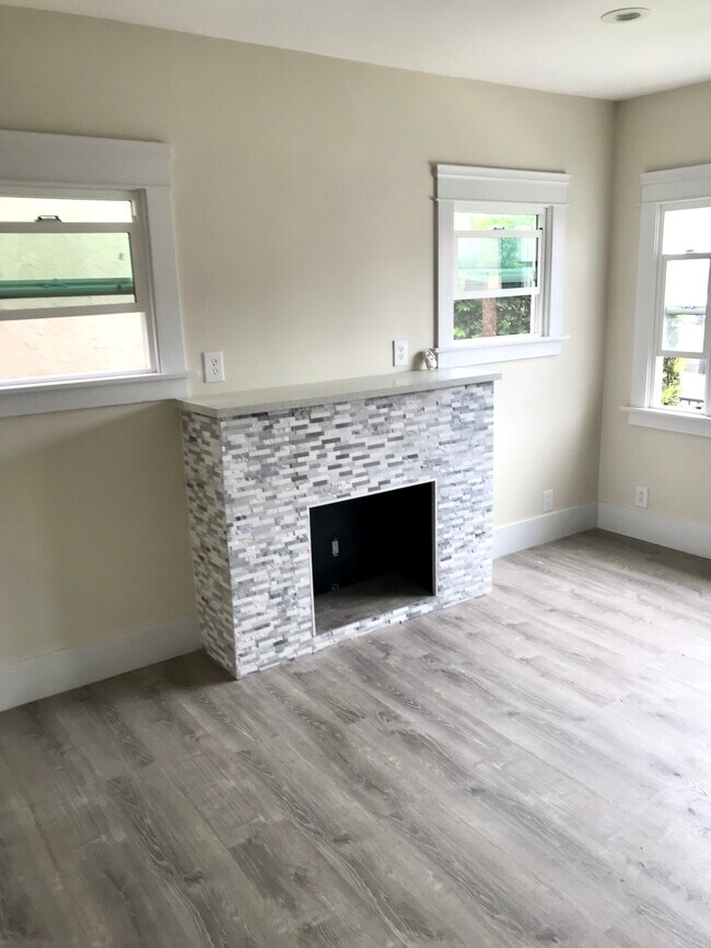 Custom fireplace, brand new dual pane windows - 3031 E 7th St