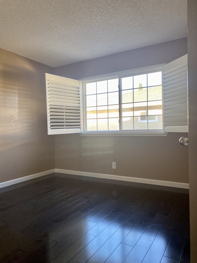2nd bedroom with real wood flooring, dual pane windows and plantation shutters - 2291 Samaritan Dr