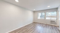 Located at 1253 Havenhurst Dr in the heart of West Hollywood, CA, this efficiently designed studio offers a clean, modern aesthetic throughout its single-floor layout. The living area is finished with light-toned hardwood-style flooring and crisp white walls, creating a bright and airy atmosphere. Recessed lighting illuminates the space, while windows overlooking mature trees bring in natural light and a touch of greenery. A wall-mounted HVAC unit provides climate control directly within the living space.

The kitchen is well-appointed with white shaker-style cabinetry, a stainless steel sink, and a full suite of stainless steel appliances including a gas range, over-the-range microwave, and dishwasher. Light countertops complement the overall clean, contemporary feel.

The bathroom features a white tiled tub-shower combo, a modern vanity with a taupe quartz countertop, an undermount sink, and brushed nickel hardware — all finished to a high standard. A dedicated closet provides practical storage. The cohesive design language — neutral tones, updated fixtures, and durable flooring — carries seamlessly through every room, making this West Hollywood studio a polished and functional urban retreat.