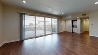 Located on N Fuller Ave in the heart of Los Angeles, CA 90046, this single-floor unit offers a thoughtfully updated layout with consistent wood-style flooring throughout. The modern kitchen is a standout feature, outfitted with white shaker cabinetry, grey countertops, a blue-toned subway tile backsplash, stainless steel appliances including a range, microwave, refrigerator, and dishwasher, along with ample storage and a window that draws in natural light. The living areas are bright and open, with large windows featuring vertical blinds that frame lush greenery views, creating a serene indoor-outdoor connection. Bedrooms are well-proportioned, each offering natural light and closet space, including a walk-in closet with full wire shelving and basket storage systems. The primary bathroom features white cabinetry, grey countertops, a framed mirror, recessed lighting, and a combined shower and soaking tub. A second bathroom provides a streamlined vanity with grey countertops and a window for natural ventilation. Completing the space is a generously sized covered outdoor terrace with open railings and sweeping views of the surrounding Los Angeles skyline and neighborhood, ideal for outdoor relaxation or entertaining.