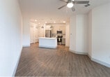 Located on Rodeo Street in Midland, Texas, this single-story unit offers a clean, contemporary design with a well-planned open-concept layout. The kitchen serves as a central hub, featuring a large island with a stainless steel sink, white quartz countertops, and stylish industrial-style pendant lighting overhead. Gray shaker-style cabinetry lines the walls, complemented by a white subway tile backsplash and a full suite of stainless steel appliances, including a refrigerator with ice maker, electric range, and built-in microwave.

The kitchen flows seamlessly into the living area, which is bright and open, benefiting from natural light through multiple windows with blinds and a glass door providing direct access to the outdoors. A ceiling fan is centrally positioned in the living space, enhancing comfort and airflow throughout.

The bedrooms continue the unit's consistent aesthetic, each finished with warm wood-look flooring, neutral white walls, and ceiling fans or natural light from windows. One bedroom includes a built-in shelving unit, offering practical storage. The bathroom is clean and functional, featuring a tub-shower combination with white tile surround, a white vanity, and wood-look flooring. Throughout the unit, consistent finishes and a neutral palette create a cohesive and comfortable living environment.