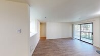 This 560 square foot apartment in Renton, Washington, offers a thoughtful layout that maximizes space and functionality. The single-floor unit features one bedroom measuring 130 square feet, providing a comfortable private retreat. The open-concept design seamlessly combines the kitchen and living room, creating a spacious feel despite the compact footprint.

Throughout the apartment, wood-look flooring adds warmth and continuity. The living area is highlighted by a sleek fireplace and sliding glass doors that open to a small balcony, allowing natural light to flood the space. The kitchen boasts white cabinetry, contrasting with stainless steel appliances and a tile floor, offering both style and practicality.

The bathroom features a combination tub-shower with built-in storage niches, optimizing the available space. A closet provides additional storage, essential in a compact living environment. The bedroom, while modestly sized, includes a window that frames views of the surrounding greenery, enhancing the sense of space.

This apartment balances modern amenities with efficient design, making it an ideal choice for those seeking a cozy, low-maintenance living space in the Renton area.