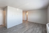 Located at 4210 Paramount Blvd in Amarillo, Texas, this single-floor unit offers a straightforward and functional layout designed for comfortable everyday living. The space features a mix of flooring types throughout, with warm light wood vinyl flooring extending across the main living and kitchen areas, while plush carpet provides added comfort in the bedroom.

The kitchen is efficiently arranged and open to the living area, featuring white cabinetry that provides ample storage, gray laminate countertops, a coil-burner electric range with a built-in overhead vent hood, a refrigerator, and a double-basin sink. The layout allows for easy movement between cooking and living spaces.

The living area is bright and open, with smooth neutral walls and a textured ceiling that adds subtle visual character. Natural light filters in throughout the unit, contributing to an airy feel.

The bedroom is a well-proportioned, quiet retreat with soft carpeting underfoot, a window fitted with blinds for light control and privacy, a baseboard heating unit, and a textured ceiling overhead. The room offers a calm, neutral atmosphere suited for rest.

A ceiling fan is installed in the main area, enhancing airflow and comfort. Overall, the unit presents a clean, practical living environment in a convenient Amarillo location.