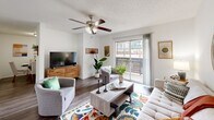 Located at 2604 Furrs St in Arlington, TX, this single-story residence offers a thoughtfully designed layout comprising a living room, dining room, kitchen, bedroom, office, hallway, bathroom, and closet. The living room is bright and welcoming, featuring wood-look flooring, a ceiling fan, and a sliding glass door that fills the space with natural light and provides outdoor access. The kitchen is well-equipped with dark cabinetry, a mosaic tile backsplash, granite-look countertops, black appliances including a refrigerator, range, and microwave, and durable wood-look flooring. The dining area offers an intimate setting with hardwood-style floors, ideal for everyday meals. The bedroom features plush carpeting, a ceiling fan, a window for natural light, and a spacious walk-in closet with generous hanging space. A dedicated office area with carpet provides a quiet workspace. The bathroom is clean and functional, featuring a granite-top vanity with wood cabinetry, a framed mirror, and a tub-shower combination. Textured ceilings and neutral white walls throughout create a cohesive, move-in-ready aesthetic.