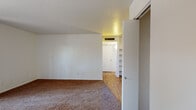 Located at 260 S Pantano Rd in Tucson, Arizona, this single-floor unit offers a practical and comfortable layout designed for everyday living. The living area is generously sized, featuring warm brown carpeting and a sliding glass door that opens directly onto a private covered patio, flooding the room with natural light and providing easy outdoor access. A ceiling fan adds to the comfort of the space, and a closet near the entry offers convenient storage. The carpeted bedrooms are well-proportioned, each featuring closets and windows that bring in natural light. The textured ceilings and clean white walls give the sleeping areas a neutral, move-in-ready feel. The kitchen is efficiently laid out with rich wood cabinetry, light countertops, wood-look flooring, and white appliances including a dishwasher, stove, and refrigerator. A built-in shelving nook provides additional storage just off the kitchen corridor. The bathroom is clean and functional, featuring a wood-vanity with a single sink, a large mirror, wood-look flooring, and a full tub-shower combination with tiled surround. Throughout the unit, a consistent mix of carpet and wood-look flooring ties the spaces together, creating a cohesive and livable environment in the heart of Tucson.