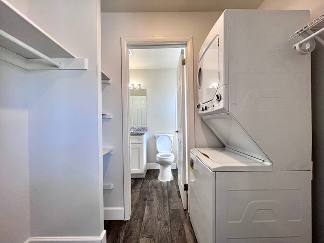 Experience modern convenience in this well-designed laundry and bathroom space. - Inertia Apartments