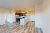 Located at 6415 Templeton Gap Rd in Colorado Springs, CO, this 2-bedroom, 2-bathroom residence offers a thoughtfully designed single-floor layout with contemporary finishes throughout. The kitchen serves as a central highlight, featuring gray shaker-style cabinetry, white countertops, a full suite of stainless steel appliances including a refrigerator with ice maker, range, microwave, and dishwasher, along with a peninsula with pendant lighting that seamlessly connects to the living area. Light wood-tone flooring flows through the main living spaces, enhancing the bright, airy ambiance. The living area opens to an outdoor balcony through a glass door, with large windows framing views of the surrounding Colorado Springs landscape. Both bedrooms are carpeted for comfort, with natural light provided by slatted blinds. The primary bedroom offers a comfortable, well-proportioned layout with a dedicated closet. The two bathrooms are finished with dark cabinetry, light wood-tone flooring, and tiled tub-shower combinations with brushed nickel fixtures. Neutral warm tones are carried throughout the space, creating a cohesive and inviting atmosphere well-suited for everyday living.