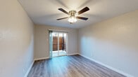 Located at 518 S Carroll Blvd in Denton, TX, this single-story, two-bedroom, one-bathroom home offers a practical and well-appointed layout. Throughout the home, wood-look luxury vinyl flooring provides a consistent, clean aesthetic, complemented by neutral-toned walls and white trim that create a bright and inviting atmosphere.

The living area is fitted with a ceiling fan and benefits from natural light, while the primary bedroom is a generously sized space featuring a sliding glass door that opens to a private fenced outdoor area — ideal for outdoor relaxation. A second bedroom includes a ceiling fan and a window that brings in natural light, offering a comfortable and airy feel.

The galley-style kitchen is efficiently designed with white cabinetry, light quartz countertops, a stainless steel sink, and white appliances including a range, microwave, and refrigerator, maximizing storage and functionality within a compact footprint.

The full bathroom is finished with classic white subway-style wall tile surrounding a full tub-shower combination, white cabinetry for added storage, and wood-look flooring that ties in with the rest of the home. A hallway connects the rooms seamlessly, and a dedicated closet provides additional storage. Ceiling fans are present throughout, enhancing comfort year-round.