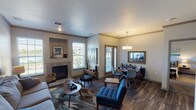 Located at 15875 E 40th Ave in Denver, Colorado, this single-story residence offers a well-designed layout with a cohesive contemporary aesthetic. The open-concept living and dining area serves as the heart of the home, featuring rich wood-look flooring, crown molding, and abundant natural light from multiple windows. A tiled fireplace with a built-in display niche anchors the living space, which flows seamlessly into the dining area. The dining space is highlighted by a pendant drum light fixture and a sliding glass door that provides outdoor access and additional natural light.

The kitchen is outfitted with white shaker-style cabinetry, dark countertops, a tile backsplash, and a full suite of stainless steel appliances, including a refrigerator, range, microwave, and dishwasher.

Two bedrooms offer comfortable retreats; one features large windows with ample natural light and plush carpeting, while the other showcases vaulted ceiling lines for added spaciousness. The primary bathroom is notably expansive, with dual vanities, dark countertops, white cabinetry, and wood-look flooring. A second full bathroom includes a single vanity with matching finishes and a tub-shower combination, maintaining design consistency throughout the home.
