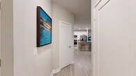 Located at 2202 Flagler Promenade Way in Maitland, Florida, this well-appointed 2-bedroom, 3-bathroom residence offers a thoughtfully designed single-floor layout with modern finishes throughout. The open-concept kitchen and living area serves as the heart of the home, featuring a sleek kitchen with crisp white shaker cabinetry, a classic subway tile backsplash, quartz countertops, stainless steel appliances including a French door refrigerator and electric range, and stylish pendant lighting over the island. Light wood-look tile flooring flows through the main living areas, adding a clean, contemporary feel. The living room is bright and welcoming, with large windows that invite natural light and offer verdant outdoor views, complemented by a ceiling fan and easy access to an exterior door. Both bedrooms are carpeted and generously proportioned, with the primary suite featuring a walk-in closet and a well-lit ensuite. The secondary bedroom also benefits from natural light and ample closet space. The bathrooms are finished with white vanities and light tile flooring, maintaining the home's cohesive neutral palette. An attached single-car garage with an automatic opener provides convenient direct access. Two dedicated closets and a hallway complete the functional layout of this move-in-ready Maitland residence.