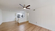 Located at 3720 W Alabama St in Houston's sought-after Galleria/Upper Kirby area, this one-bedroom, one-bathroom unit offers a well-designed layout across a single floor. Light wood-style flooring flows consistently throughout the space, creating a cohesive and clean aesthetic. The open-concept living and kitchen area is bright and welcoming, with large windows allowing natural light to fill the room and a ceiling fan overhead for added comfort. The kitchen is thoughtfully appointed with white shaker-style cabinetry, white quartz countertops, a classic subway tile backsplash, and a full suite of stainless steel appliances including a refrigerator, range, and built-in microwave. A peninsula with an integrated sink adds functional counter space and connects the kitchen seamlessly to the living area. The bedroom is a comfortable retreat, featuring a ceiling fan, a large window with outdoor views, and access to a dedicated closet. The bathroom continues the clean, modern palette with white cabinetry offering ample storage, a wide vanity mirror, white quartz countertops, and a full soaking tub with shower. The unit's consistent finishes and well-organized layout make it a practical and attractive living space.