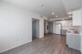 Located at 4320 44th Street in San Diego, CA, this efficiently designed one-bedroom, one-bathroom unit offers a thoughtful layout across a single floor. The open-plan living area seamlessly integrates the kitchen, dining, and living spaces into one bright, cohesive zone. Light wood-style flooring runs throughout, contributing to a clean and airy aesthetic.

The kitchen is well-equipped with white upper cabinetry featuring brushed nickel hardware, textured lower cabinets in a neutral wood-tone finish, a double-basin sink, a white electric range, and a full-size refrigerator. Recessed lighting overhead provides consistent illumination throughout the kitchen and living area, while a large window with vertical blinds fills the space with natural light.

The bedroom is a cozy, well-proportioned room with the same light flooring, neutral white walls, and a window that brings in additional natural light. Two closets offer practical storage solutions for the unit.

The bathroom is clean and functional, featuring a full bathtub with a shower, a curved shower rod, and accessibility-friendly grab bars along the walls. Light wood-tone tile flooring ties the bathroom's aesthetic to the rest of the unit. The overall palette of whites and light neutrals throughout creates a calm, move-in-ready environment.