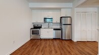 Located at 100 Shellbark Way in Savannah, Georgia, this residential home offers a well-designed layout with a mix of hardwood-style and carpeted flooring throughout. A carpeted staircase with a warm wood handrail leads to the upper level, providing a clean and classic transition between floors.

The kitchen is outfitted with white shaker-style cabinetry, a subway tile backsplash, dark-toned countertops, and a full suite of stainless steel appliances including a range, over-the-range microwave, dishwasher, and refrigerator. Rich hardwood-style flooring anchors the space, giving it a warm and functional character.

The bedrooms feature plush wall-to-wall carpeting and ceiling fans, with windows that bring in natural light and offer views of the surrounding greenery. One room transitions between carpeted and hardwood-style flooring, adding visual interest to the space.

An open upper landing area with a knee wall overlooks the lower level, adding architectural dimension and an airy, connected feel to the layout. The bathroom is well-appointed with white cabinetry, a dark countertop vanity, a large mirror, and a tub-shower combination, all set on hardwood-style flooring. Neutral tones and clean finishes throughout create a bright and inviting atmosphere.