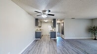 Located at 4407 Oakhollow Dr in Sacramento, California, this one-bedroom, one-bathroom residence offers a well-organized single-floor layout designed for comfortable everyday living. The open-concept living and dining area is finished with neutral gray walls, a textured ceiling, and a combination of wood-look vinyl flooring and plush carpet. A large sliding glass door fitted with vertical blinds fills the living space with natural light and provides access to an outdoor area with views of surrounding greenery.

The galley-style kitchen is efficiently designed with gray cabinetry, granite-look countertops, a stainless steel sink, white appliances including a gas range and refrigerator, and a ceiling fan with integrated lighting overhead. Wood-look vinyl flooring runs throughout the kitchen, complementing its clean, functional aesthetic.

The generously sized primary bedroom features carpet flooring, a textured ceiling, and two windows that allow ample natural light. A sliding-door closet provides dedicated storage space. The full bathroom includes a combined shower and soaking tub with built-in shelving, a toilet, and a small window for ventilation.

Throughout the residence, consistent neutral tones, clean finishes, and practical design elements create a cohesive and inviting atmosphere.