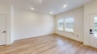 Located at 4009 Connection Point Blvd in Charlotte, NC, this two-story, 2-bedroom, 3-bathroom home offers a thoughtfully designed layout spread evenly across two floors. The main level features a bright, open-concept living, dining, and kitchen area unified by light hardwood-style flooring and crisp white walls. The kitchen is a standout, showcasing a large quartz waterfall island with an undermount sink and matte black faucet, white shaker cabinetry, stainless steel appliances, a subway tile backsplash, and bold pendant lighting. A convenient half bath on the main floor adds practicality for guests. The living area is airy and open, with recessed lighting and a sliding door providing access to the outdoors. Upstairs, both bedrooms are generously proportioned, each featuring ceiling fans, large windows that invite abundant natural light, and access to well-appointed bathrooms with white vanities and matte black hardware accents. The primary bedroom includes an en-suite bathroom. With six closets distributed throughout, storage is plentiful. The clean, modern aesthetic is carried consistently through every room, making this a well-organized and stylish home in the Charlotte area.
