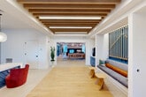 Located at 2119 Post Rd in Warwick, Rhode Island, this generously sized single-floor amenity space offers a comprehensive suite of features across a substantial footprint. The welcoming entrance opens into a bright, open corridor adorned with warm wood-beam ceilings, light hardwood flooring, and modern built-in seating — setting an inviting, polished tone throughout.

The interior encompasses multiple lounge areas, including a stylish social lounge with a tray ceiling, curated wall art, ocean-inspired area rugs, and comfortable sectional seating. A cozy reading nook features built-in shelving, natural light from large windows, and plush accent chairs. The fitness center stands out with soaring double-height ceilings, large windows, ceiling fans, full-length mirrors, and a comprehensive selection of cardio and strength equipment. Four dedicated offices, a hallway, utility rooms, and a closet round out the interior program.

Outdoors, the space transitions to a resort-style courtyard highlighted by a sparkling pool lined with lounge chairs and umbrellas. A lush lawn area features oversized chess, bistro seating, and a grilling station, all accented by strung bistro lighting that creates an inviting evening atmosphere. The surrounding multi-story building frames the outdoor space with balconies and contemporary architectural detailing.