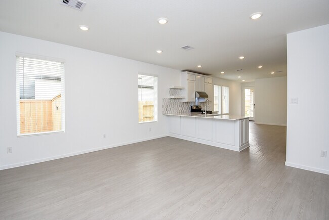 open concept living room open to kitchen - 6714 Iron Clover Dr