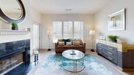 Located at 386 Attenborough Dr in Rosedale, MD, this single-floor, 2-bedroom, 2-bathroom home offers a thoughtfully designed layout with a seamless flow between living spaces. The open-concept kitchen, dining, and living area serves as the heart of the home. The kitchen is outfitted with gray shaker-style cabinetry, stainless steel appliances including a gas range, microwave, dishwasher, and refrigerator, complemented by light quartz countertops. A peninsula with seating provides a casual dining option beneath modern pendant lighting. The living room features wood-look flooring, large windows that invite natural light, and a striking fireplace with a dark tile surround and white mantle. A patio door offers additional access to the outdoors. Both bedrooms are carpeted and well-sized, with the primary bedroom offering ample space and closet storage. The two bathrooms mirror each other in style, featuring gray cabinetry, white countertops, and tub-shower combinations with wood-look tile flooring. Additional conveniences include three closets, a pantry, a dedicated laundry area, and a hallway connecting the private spaces. Neutral wall tones and consistent finishes throughout lend the home a cohesive, modern aesthetic.