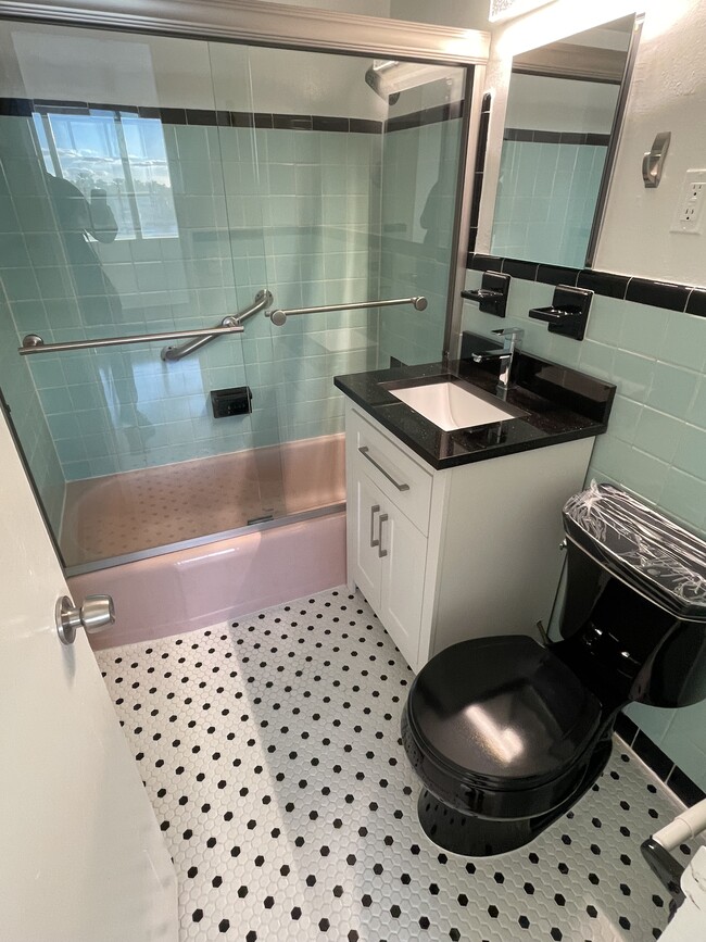 Miami Art Deco style bathroom with modern renovations - 6484 Indian Creek Dr