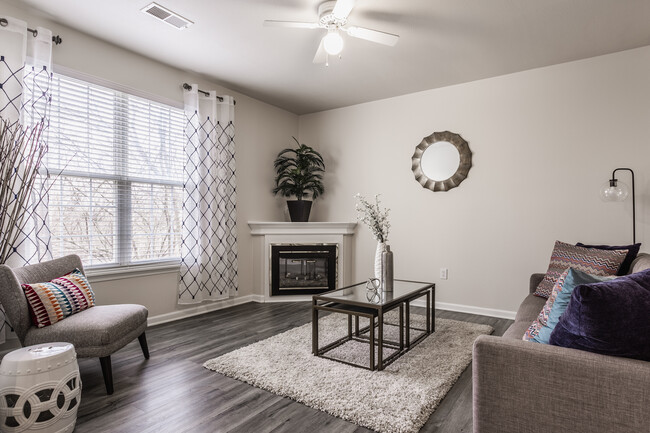 Living Room with Fireplace and Ceiling Fan - Riverchase Apartments