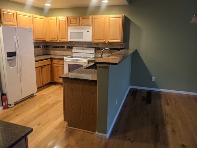 Kitchen and dining area with open, standing bar - 1703 Whitehall Dr
